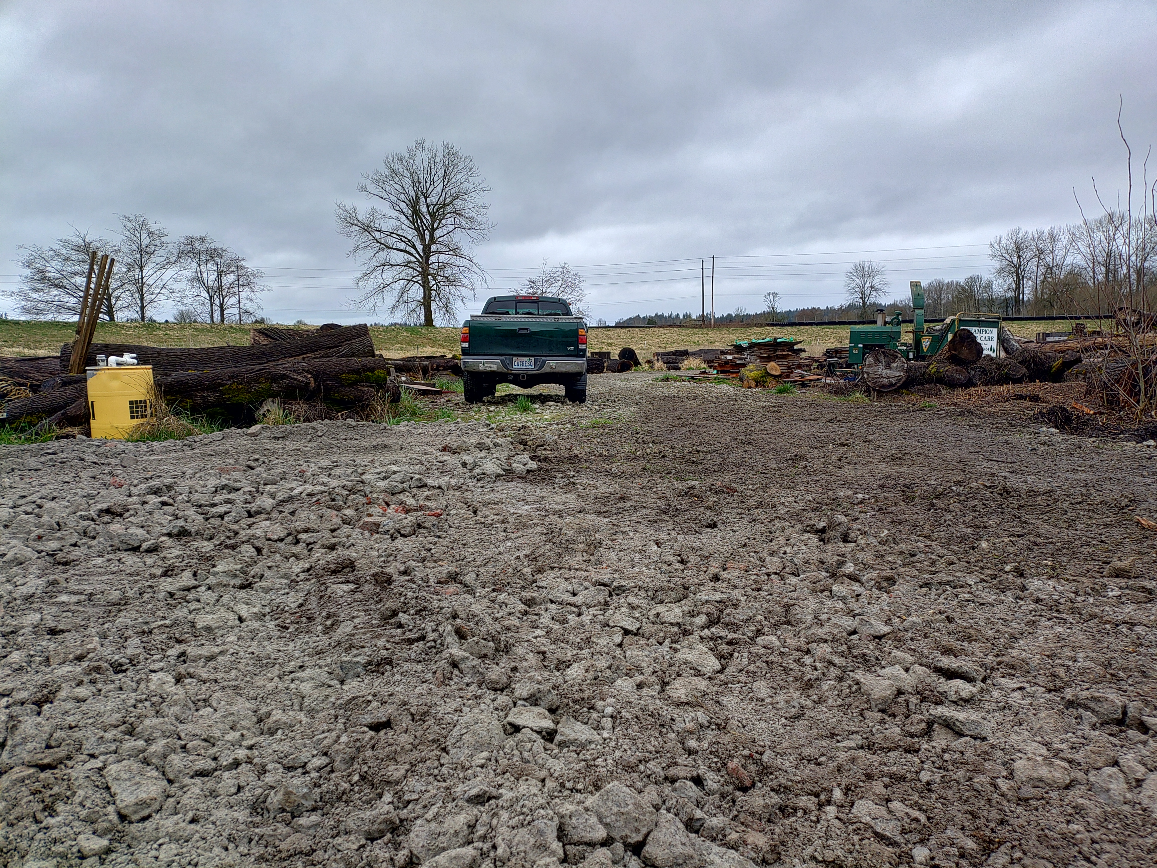 An illustration of a tractor mower at work in a meadow, with grass clippings piled on the blade, set against an agile back...